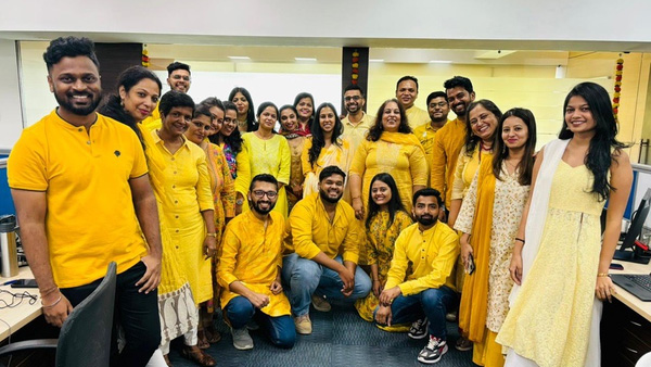 India colleagues dressed in gold colored clothing