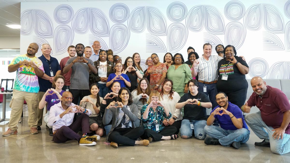 Team picture with everyone making heart sign with hands