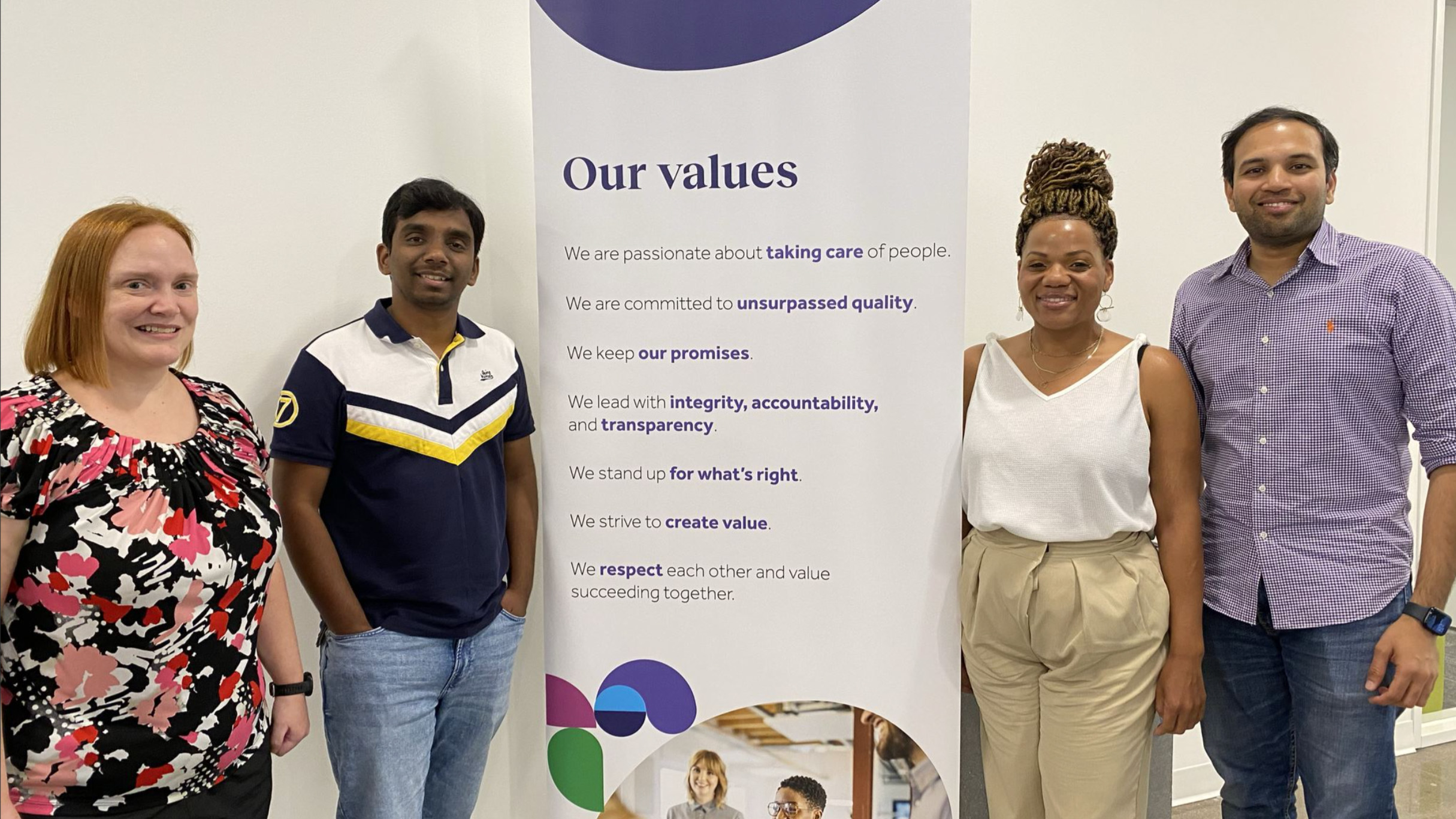 Teladoc Health employee smiling with a sign 