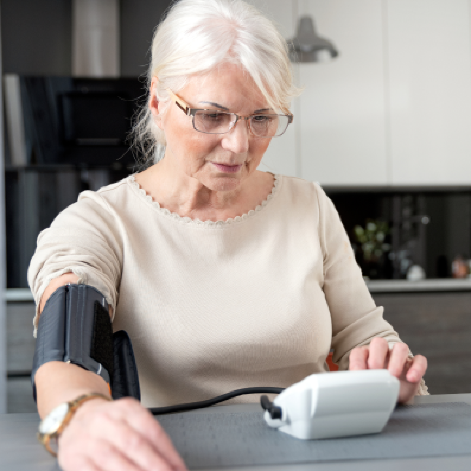 Woman looking at her hypertension device