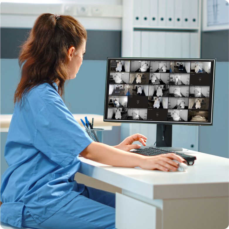 Nurse viewing patient rooms on a computer