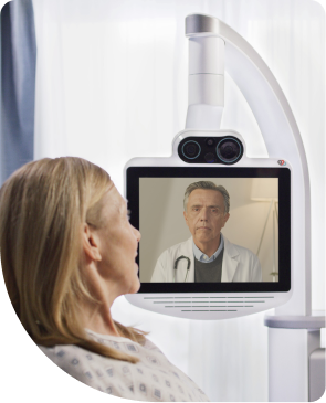 Woman gets assistance from a doctor via a Teladoc Health device