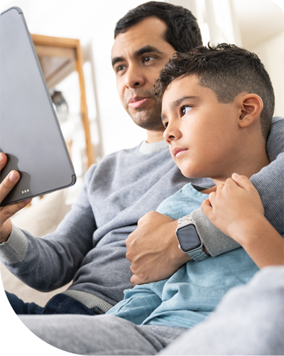 Father and sone looking at tablet