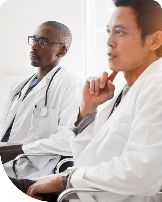 Two doctors listening to someone speaking