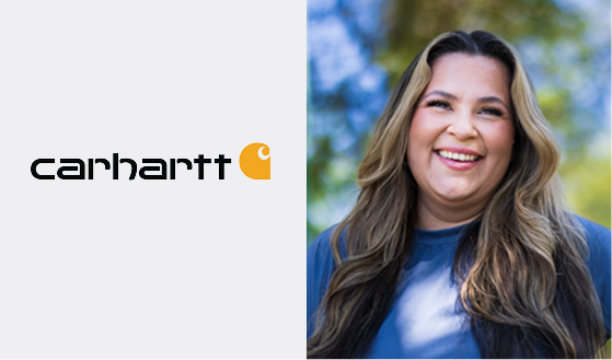 Smiling woman next to the Carhartt logo