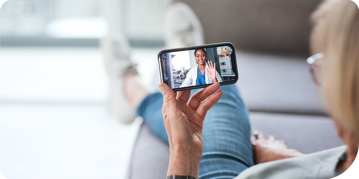 Person holding phone showing doctor on screen